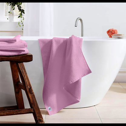 Pure cotton waffle bath towel in pink hanging in bathroom