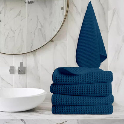 Pure cotton waffle hand towel in navy blue on towel rail