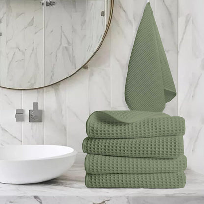 Pure cotton waffle hand towel in sage green on towel rail