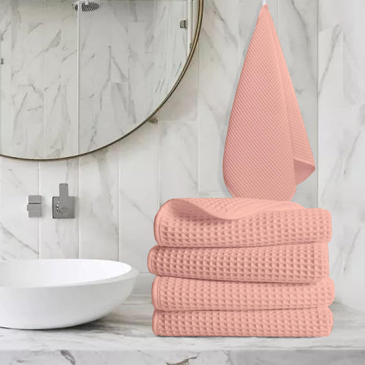 Pure cotton waffle hand towel in peach on towel rail