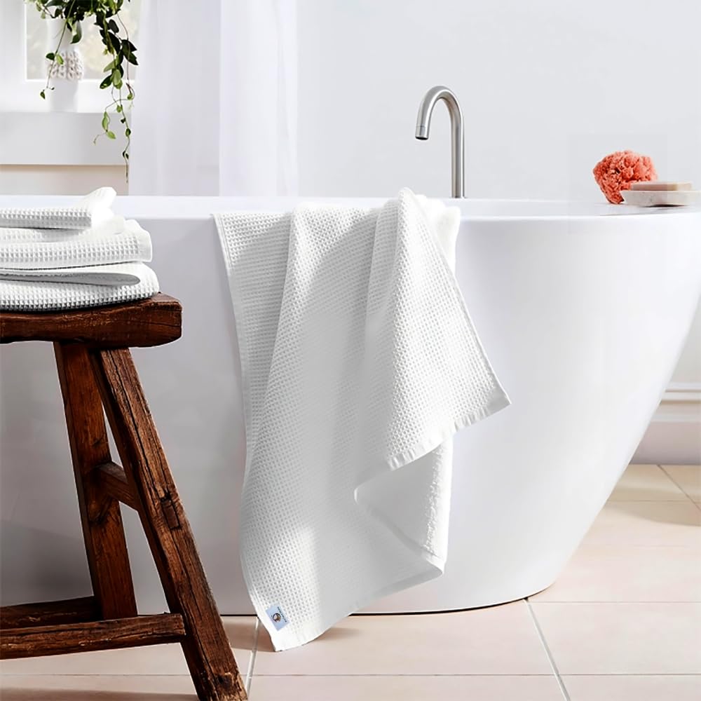 Pure cotton waffle bath towel in white hanging in bathroom