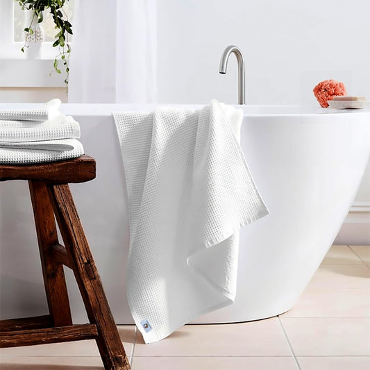 Pure cotton waffle bath towel in white hanging in bathroom