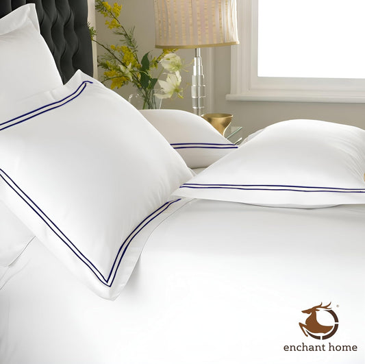 White and navy blue 500 TC pillow covers on bed – view 2