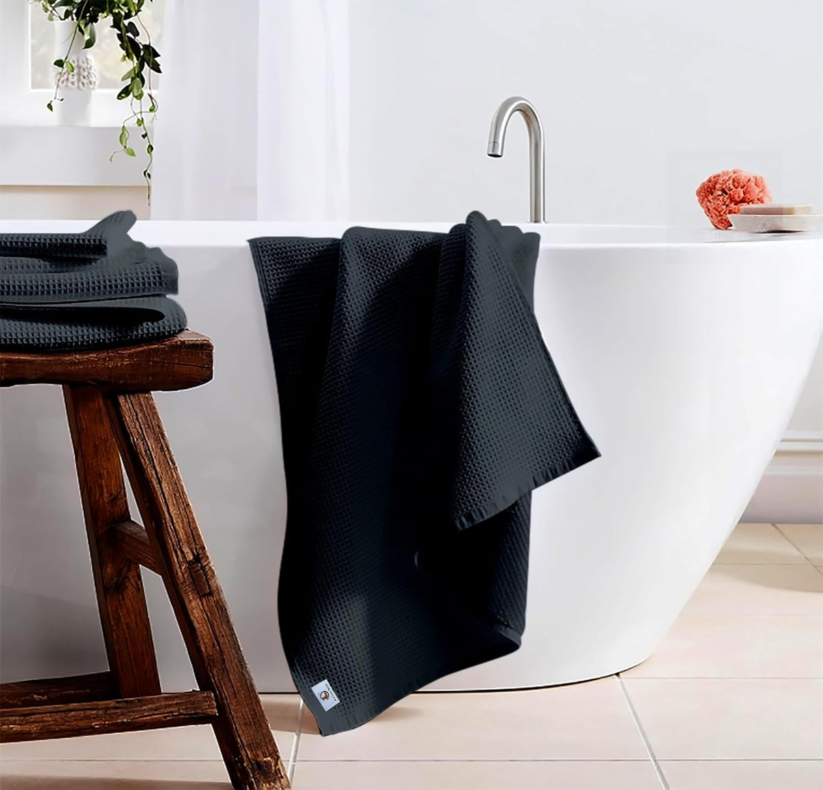 Pure cotton waffle bath towel in charcoal hanging in bathroom