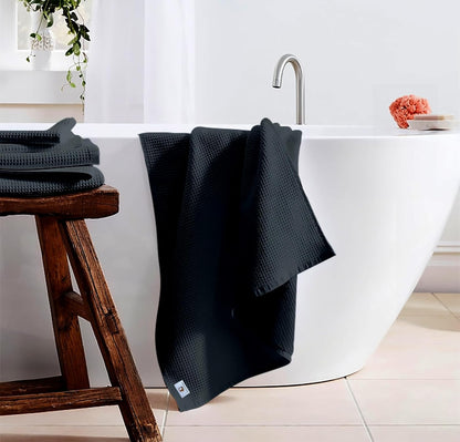 Pure cotton waffle bath towel in charcoal hanging in bathroom