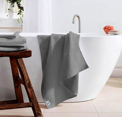 Pure cotton waffle bath towel in silver hanging in bathroom